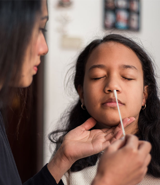 Teen girl getting nose swab
